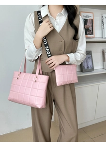 Close-up of pink quilted tote bag and crossbody set with embroidered LOVE strap