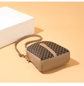 Detail view of small crossbody bag with geometric pattern and gold hardware