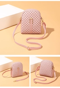 Detail view of pink crossbody cell phone bag featuring dual zippers and gold buckle