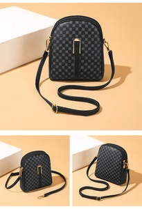 Detailed view of the multi-layer zipper compartments and gold hardware on grey crossbody bag