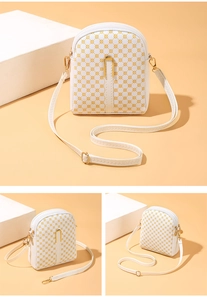 Macro view showing the yellow geometric print and gold U-shaped hardware on this crossbody bag