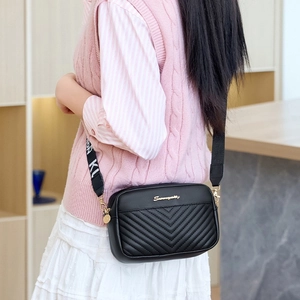 Black V-quilted camera bag with gold hardware and stylish wide logo strap for women