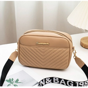 Khaki V-quilted faux leather crossbody bag with lettered strap on a white surface