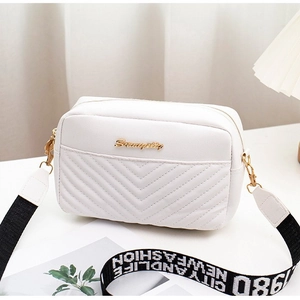 White crossbody bag with V-shaped quilting and contrast lettered canvas shoulder strap