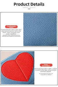 Detail view of blue litchi pattern PU leather with a red heart patch and stitching
