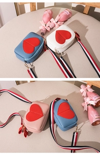 Detail showing various colors of lychee pattern crossbody bags with heart patches