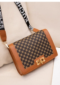 Détail du sac carré à imprimé avec bandoulière large en tissu et fermoir doré