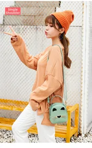 Detail of mint green cat-shaped crossbody bag with 3D ears and whisker stitching detail