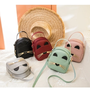 Detail shot of five colorful mini cat-ear backpacks with metal whiskers and heart accents