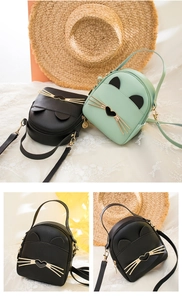 Detailed view of cat-ear mini backpack with heart-shaped metal buckle and matte PU leather