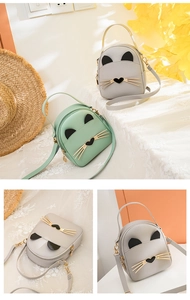 Detail of cute cat-shaped mini PU leather backpacks in mint green and light grey colors