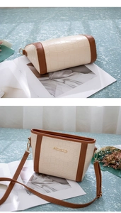 Detailansicht der Eimer-Tasche mit Elefanten-Struktur, Kontrastbesatz und Logo-Detail