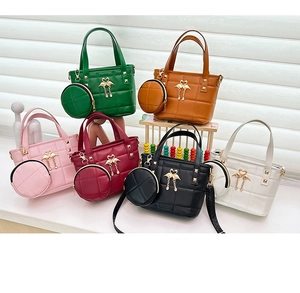Close-up of quilted PU leather tote bags in six colors with golden swan hardware and charms
