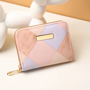 Pastel patchwork faux leather coin purse with sequins and gold zipper on a beige surface