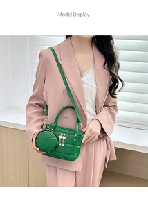 Fashionable emerald green quilted tote bag with a small round pouch and golden swan charm