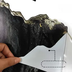 Detail showing peeling process of a mountain landscape wall sticker with A4 size scale
