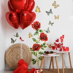 Detail of 3D red rose and golden butterfly wall stickers on a clean white wall