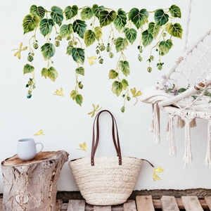 Detail of ivy green vine wall stickers with gold foil butterflies in a cozy living room decor