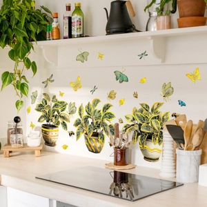 Removable wall stickers featuring green potted plants and golden butterflies for home decor