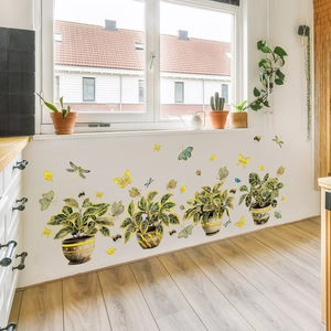Detail of hand-painted potted plant wall stickers with gold accents for home decoration