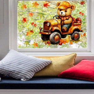 Detailed view of autumn bear window sticker on glass with maple leaves and tractor decor