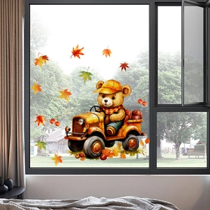 Detail of fall window sticker with cute bear driving a truck and colorful maple leaves