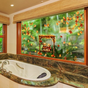 Autumn window clings showing cute teddy bears on a swing with fallen maple leaves