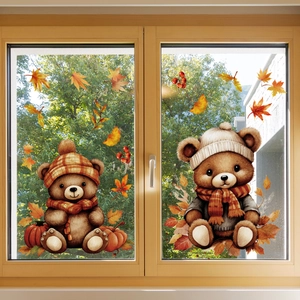 Detailed view of autumn bear window decals with maple leaves and pumpkins on glass pane