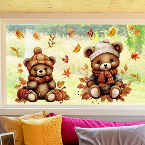 Detail of cute bears window stickers with autumn maple leaves and pumpkins for home decor