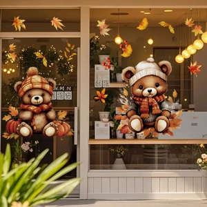 Detail of cozy autumn window stickers featuring cartoon bears, pumpkins, and maple leaves