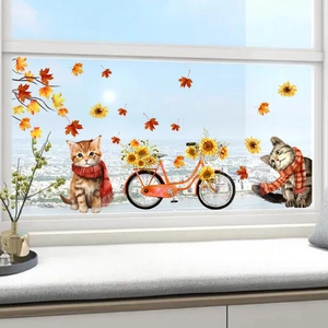 Detail of autumn window decals featuring cozy cats, sunflowers, and orange bicycle
