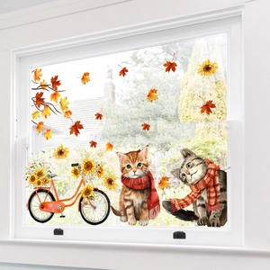 Detail of autumn window clings featuring cute cats, sunflowers, and fall maple leaves