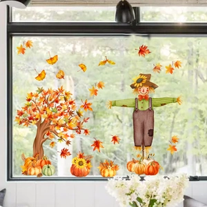Detail view of Thanksgiving window stickers featuring scarecrow, maple tree and pumpkins