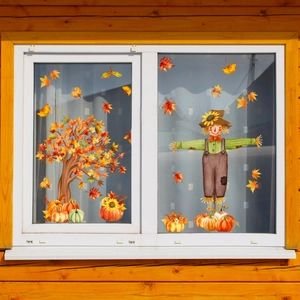 Detail view of fall window clings with maple leaves and pumpkins on glass panes