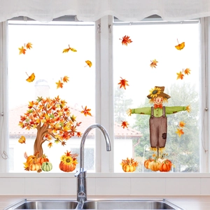Detail of autumn harvest window clings with maple tree and scarecrow on kitchen glass