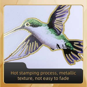 Macro detail of bird wall sticker with gold foil stamping and purple floral accents