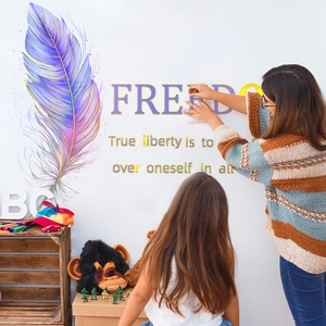 Macro detail of colorful feather wall decal and freedom text being applied to a white wall