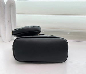 Close-up of black lychee grain leather handbag base and matching coin purse set
