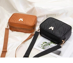 Detail of stitched camera bags with butterfly buckles and wide adjustable straps