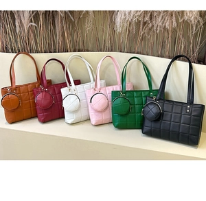Quilted tote bags in six colors with matching mini round pouches on an elegant display
