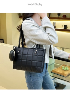 Close-up of black quilted tote bag with gold studs and a matching round coin purse