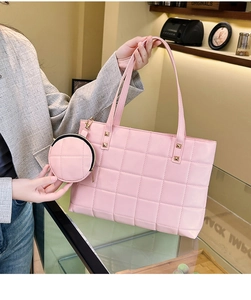Detail of light pink quilted tote bag with matching round coin purse and gold rivets