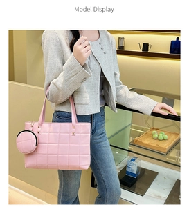 Pink quilted leather tote bag detail with classic square stitching and round charm pendant