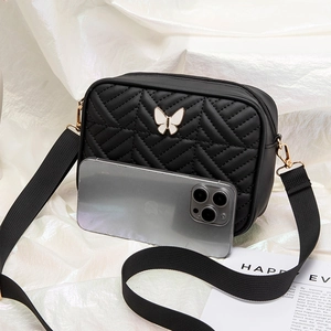 Black quilted crossbody camera bag with butterfly ornament and wide fabric strap