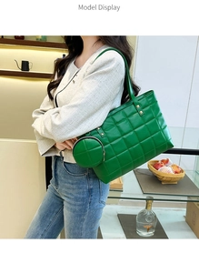 Green quilted tote bag for women with matching round coin purse shown on model