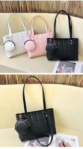 Detail of quilted tote bag set including matching round coin purse and metal rivets