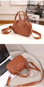 Close-up of brown quilted shell bag with gold hardware and removable shoulder strap