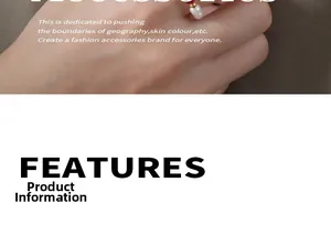 Detail of red rope ring featuring a white pearl and gold beads with woven texture