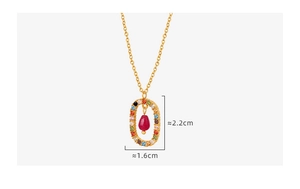 Detailed view of an oval gold pendant with colorful zircon stones and red teardrop gem