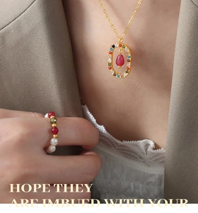 Detail of elegant gold necklace with multi-color stones and matching pearl ring on a model